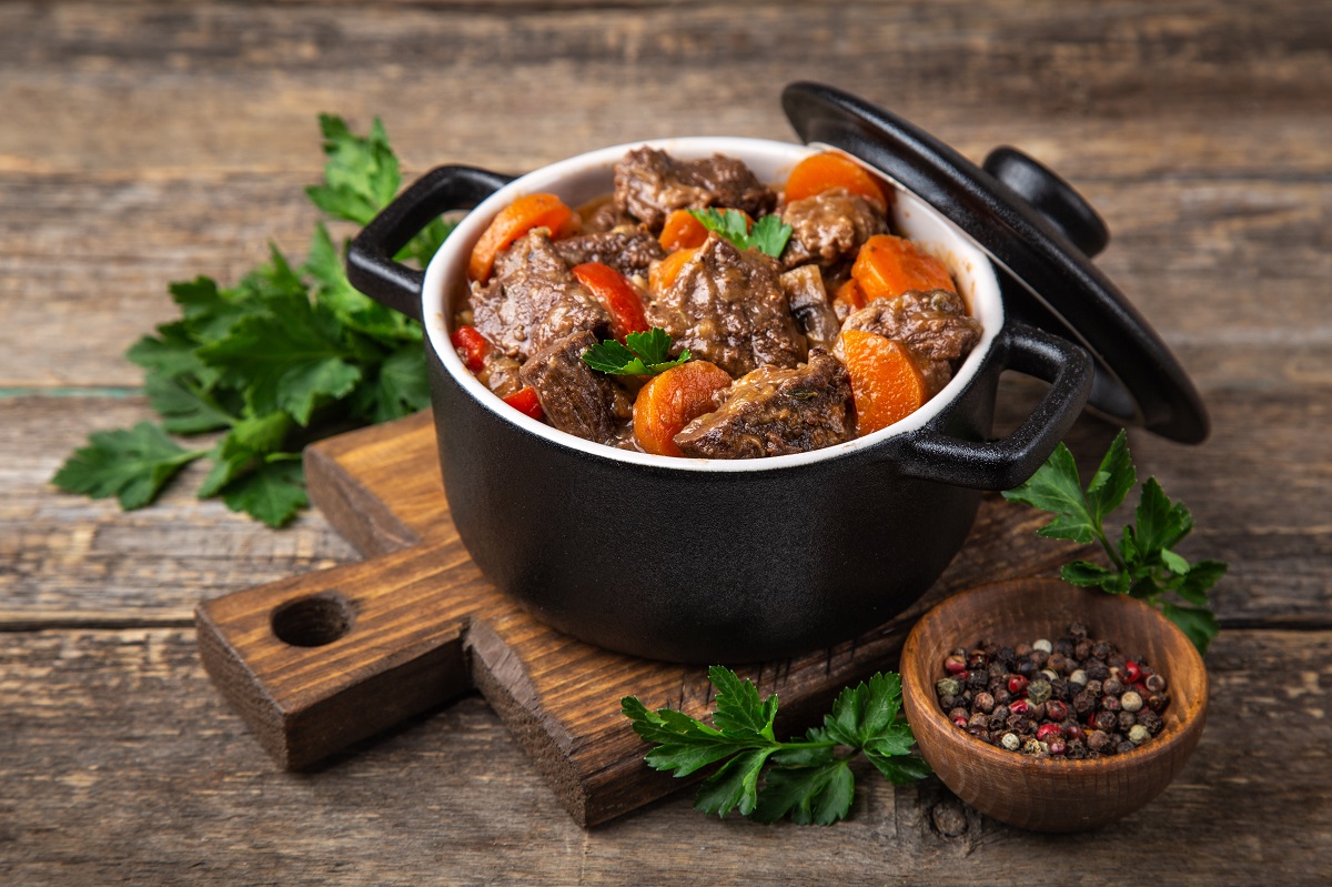 Beef,Stew,With,Vegetables,In,Black,Pot,On,Dark,Wooden